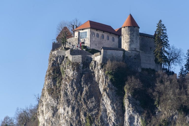 Exterior view of Bled Castle standing on a cliff above Lake Bled