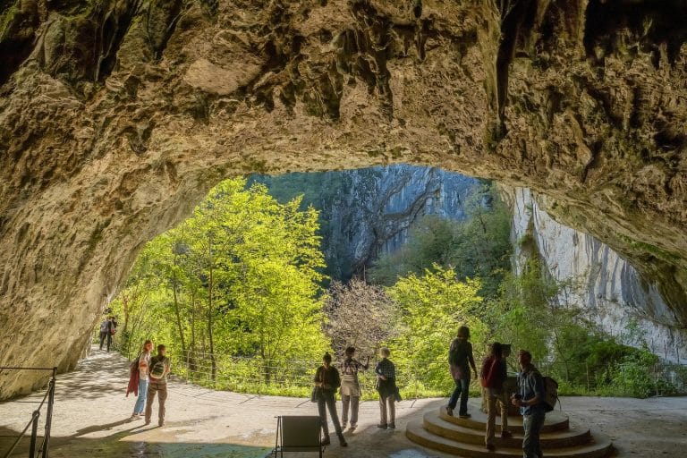 Visitors inside the vast underground canyon of Škocjan Caves in Slovenia
