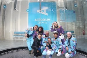 Group of visitors posing in front of the Aerodium Logatec wind tunnel