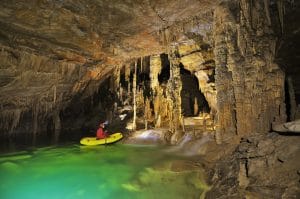 Inflatable boat beside limestone formations at Kalvarija in Križna Jama Cave