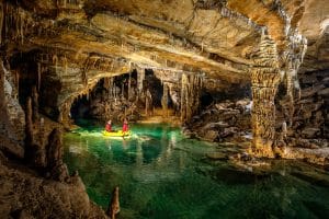 Inflatable boat on the underground water route toward Kalvarija in Križna Jama Cave