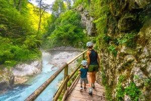 Visitors walking beside the Radovna River on the Vintgar Gorge trail