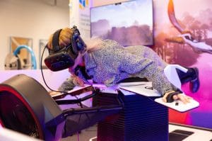 A visitor wearing a VR headset lies face down on the Birdly flight simulator at Tehnopark Celje.